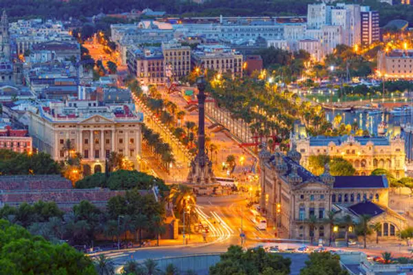 Aerial view over square Portal de la pau, and Port Vell marina and Columbus Monument at night in Barcelona, Catalonia, Spain