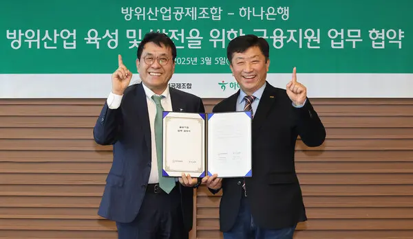 하나은행은 5일 방위산업공제조합과 K-방위산업의 육성 및 금융 지원을 위한 업무협약을 체결했다. 이날 협약식에 참석한 김진우 하나은행 중앙영업그룹 부행장(왼쪽)과 김희철 방위산업공제조합 상근부이사장이 기념촬영을 하고 있다. [출처: 하나은행]