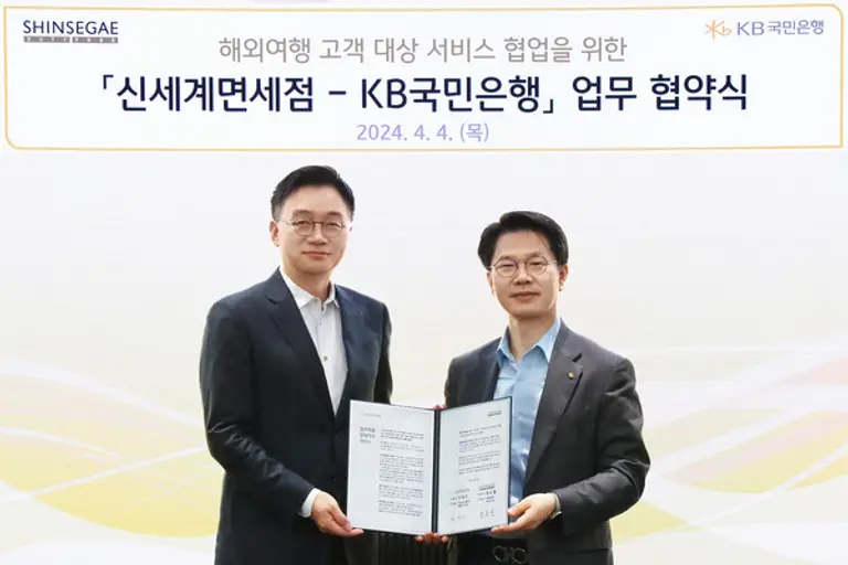 지난 4일 서울 영등포구 KB국민은행 신관에서 열린 업무협약식에서 양호진 신세계면세점 영업본부장(왼쪽)과 박병곤 KB국민은행 부행장(오른쪽)이 기념 촬영을 하고 있다.