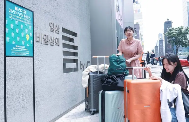 강남역 부근 MZ취향 커뮤니티 ‘일상비일상의틈byU+’에서 관광객이 여행 캐리어 보관 서비스를 신청하고 있는 모습