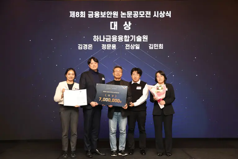 지난 7일 열린 제8회 금융보안원 논문 공모전 시상식에서 김철웅 금융보안원장(왼쪽 세 번째)과 김민희 하나금융융합기술원 어드밴스드 AI 랩장(왼쪽 다섯 번째)이 하나금융융합기술원 직원들과 기념촬영을 하고 있다. [출처: 하나은행]