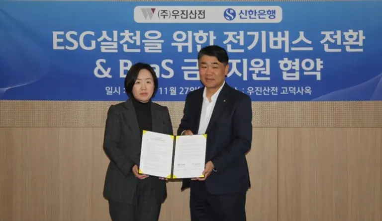 신한은행 용운호 영업추진3그룹장(오른쪽)과 ㈜우진산전 김정현 대표이사가 지난 27일 서울 강동구 우진산전 고덕 사옥에서 ‘ESG실천을 위한 전기버스 전환 BaaS형 금융지원 업무협약을 체결했다. [출처: 신한은행]