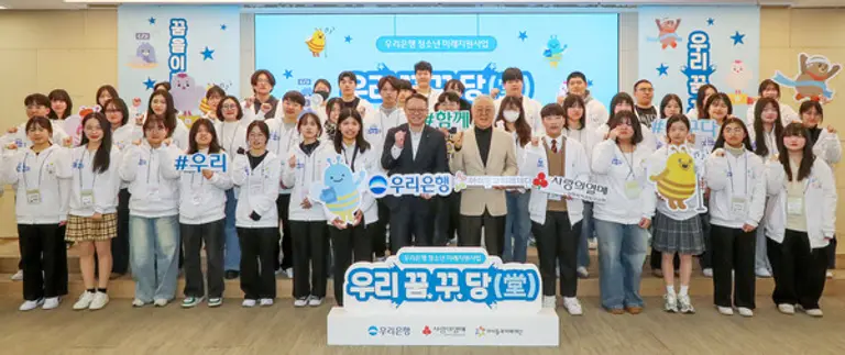 정진완 우리은행장(앞줄 오른쪽 7번째)와 아이들과미래재단 이훈규 이사장(앞줄 오른쪽 6번째)이 20일 서울 중구 우리은행 본점에서 열린 발대식에서 미래세대 청소년들을 격려했다. [출처: 우리은행]