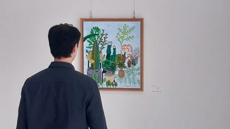 휴젤 사내에 전시된 장애예술인들의 작품을 임직원이 감상하고 있다.