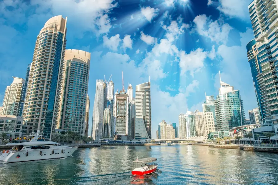 Buildings and skyline of Dubai Marina at dusk.