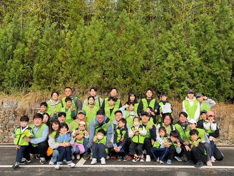 현대엔지니어링 임직원 및 임직원 가족이 서울 상암동 노을공원에서 생태숲 가꾸기 봉사활동 후 기념사진을 촬영하고 있다. (사진제공=현대엔지니어링)