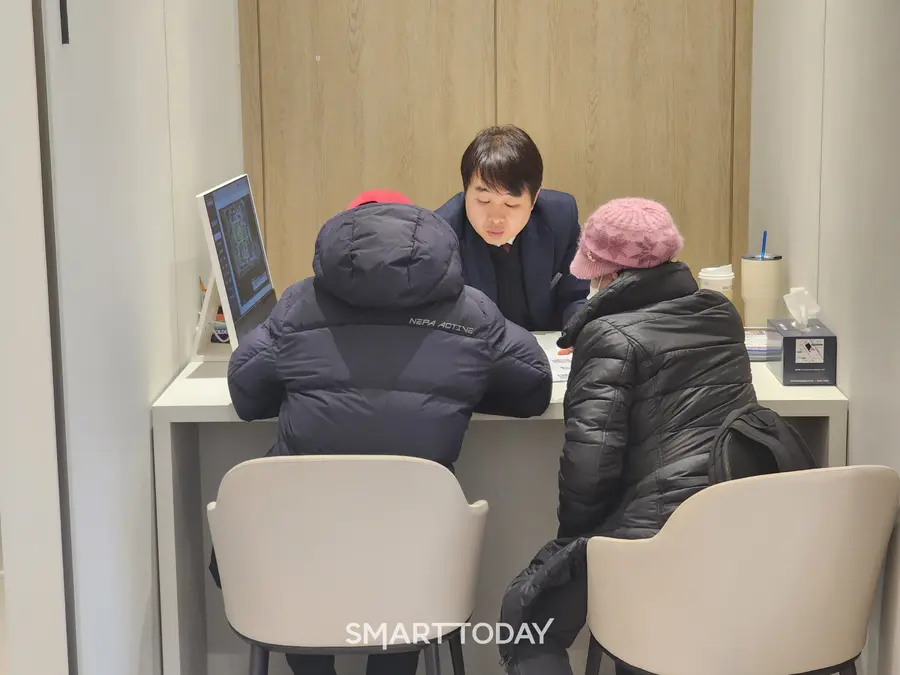 노부부가 견본주택 1층 안내창구에서 청약 관련 상담을 받고 있다. 출처=김종현 기자