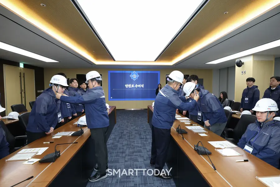 김보현 대표이사(왼쪽)와 심상철 노동조합 위원장이 신입사원에게 안전모를 씌워주고 있다. (사진제공=대우건설)