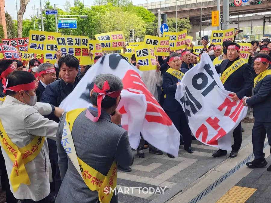 집회 참가자들이 '대웅제약 유통갑질' 현수막을 찢고 있다. 출처=김종현 기자